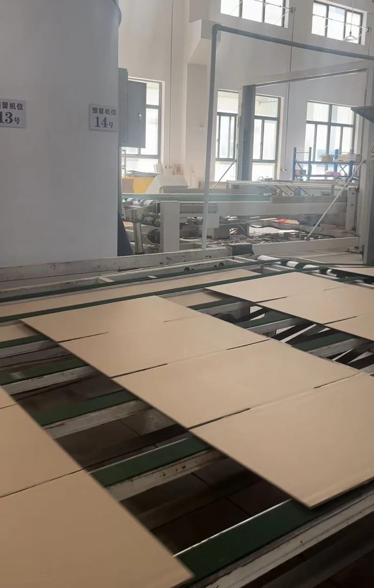 Corrugated box sheets moving along the Pakoro production line